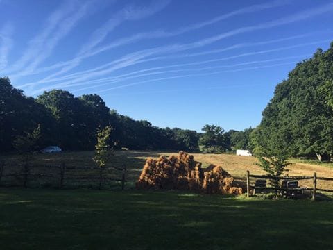 Serene outdoor venue in Sussex with haystack, perfect for rustic weddings and retreats.