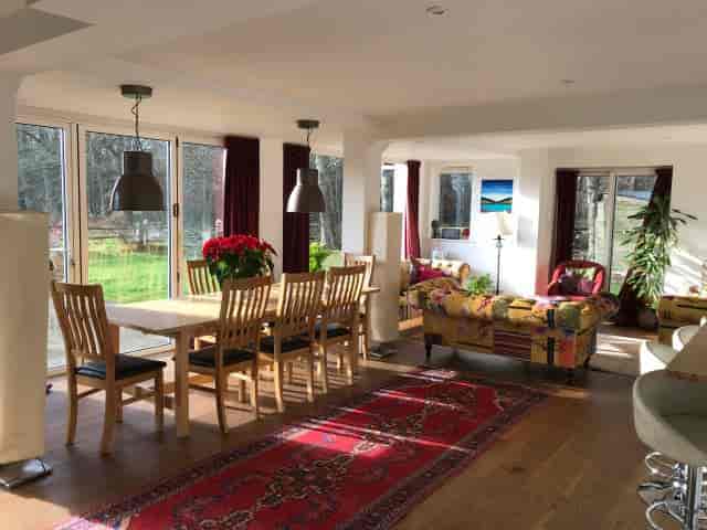 Bright meeting space in A Sussex House with large dining table for workshops and gatherings.