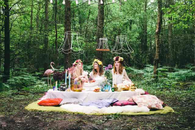 Whimsical outdoor venue in Sussex for unique events with vintage decor and lush forest backdrop.