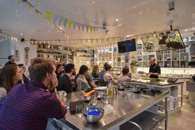 Vibrant professional kitchen for team-building culinary workshops at The Avenue Cookery School.