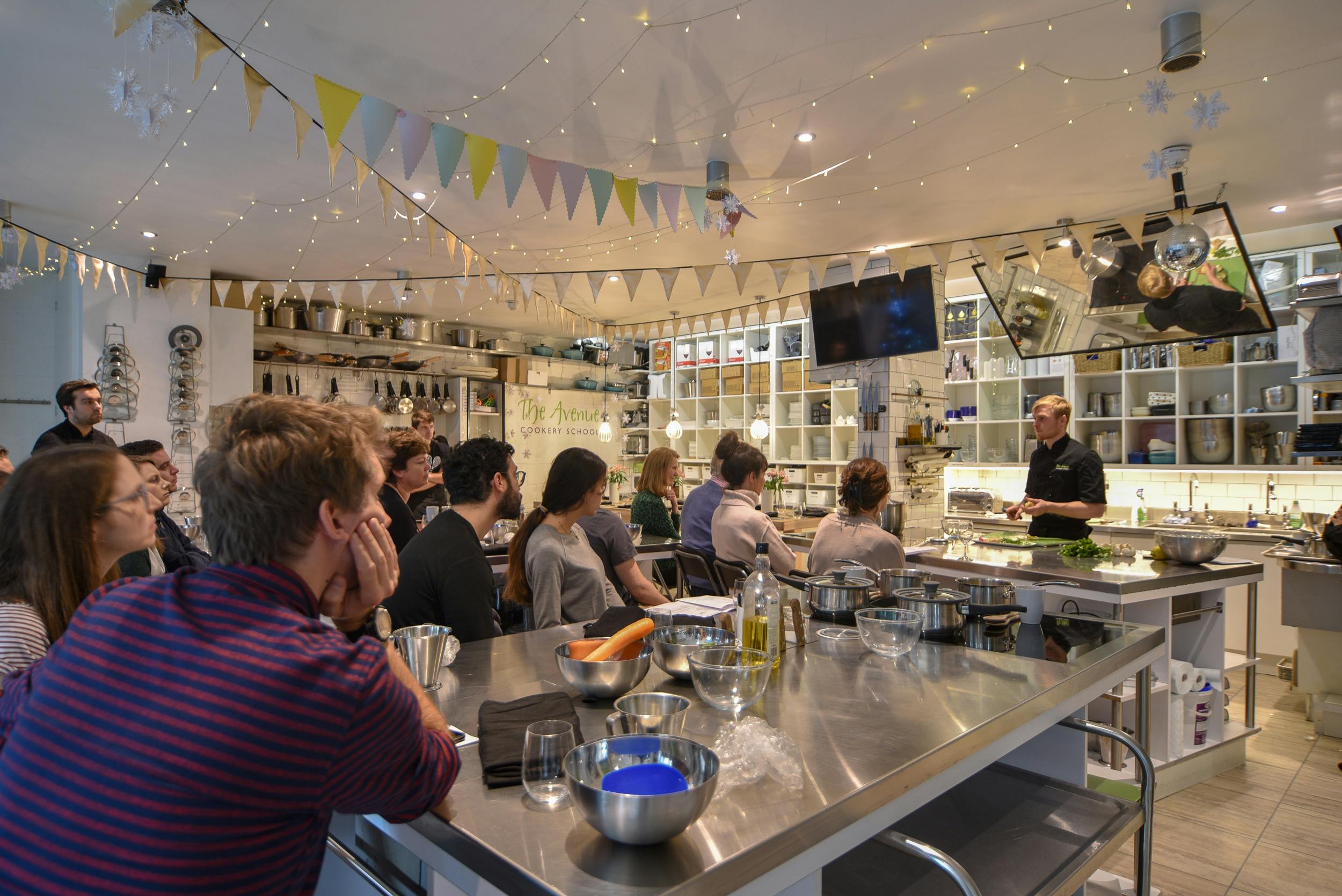 Vibrant professional kitchen for team-building culinary workshops at The Avenue Cookery School.