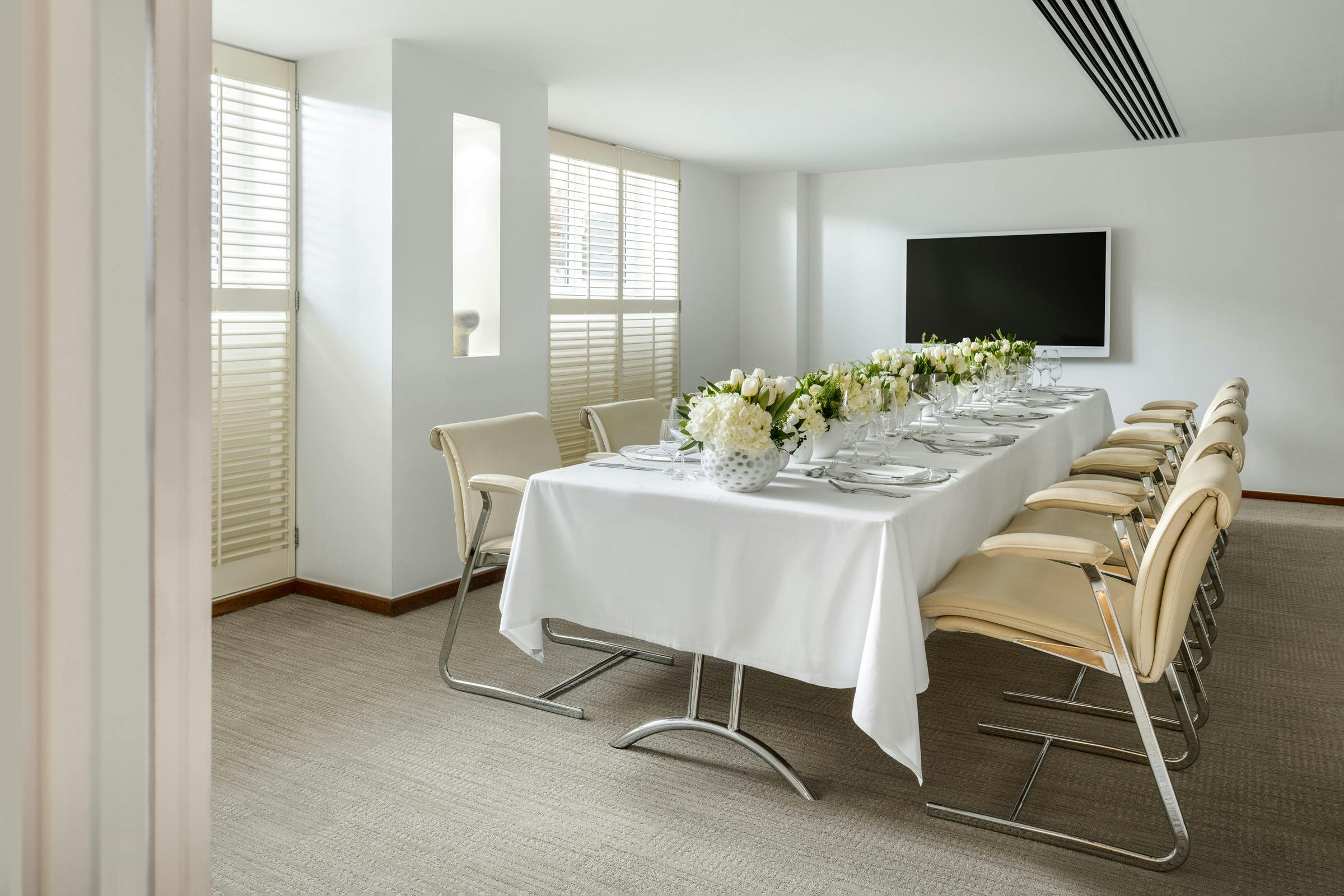 Met Boardroom at COMO Metropolitan London, elegant dining setup for corporate meetings.