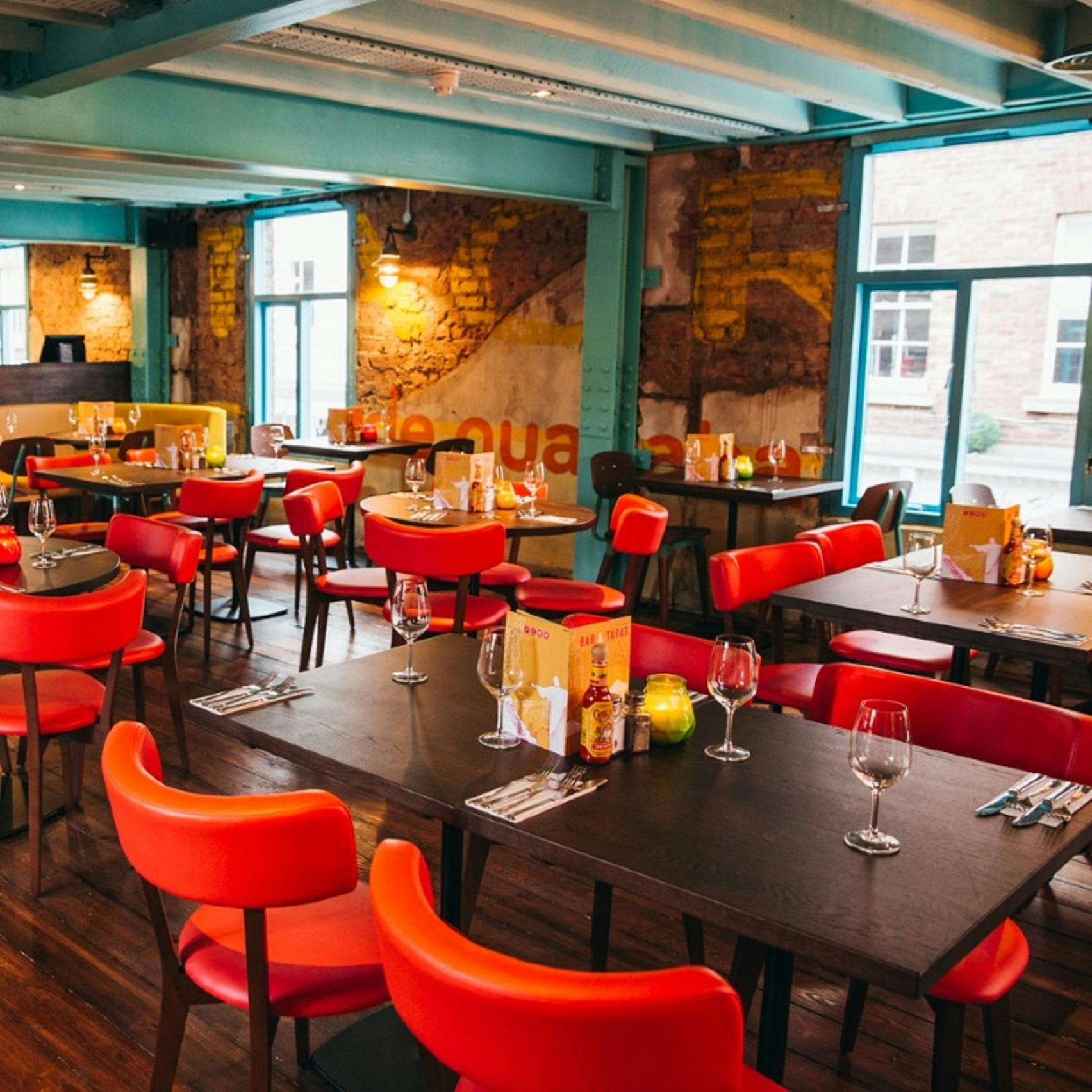 Private room in Las Iguanas York with colorful chairs, perfect for casual meetings and events.