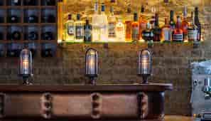 High-end bar at The Hide with warm lighting for VIP welcome receptions and networking events.
