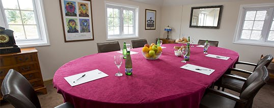 Boardroom at Sandford Springs Hotel with oval table, ideal for meetings and events.