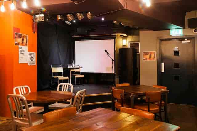 Versatile event space at The Other Place, warm lighting, ideal for talks and gatherings.
