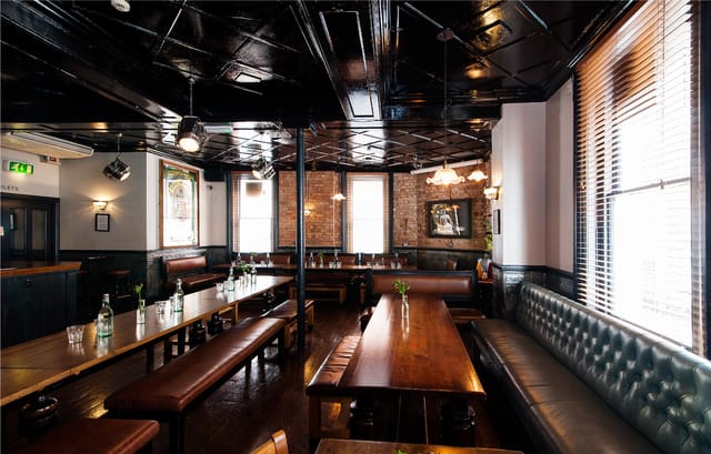 Stylish Upstairs Private Bar with leather seating, perfect for corporate events and gatherings.
