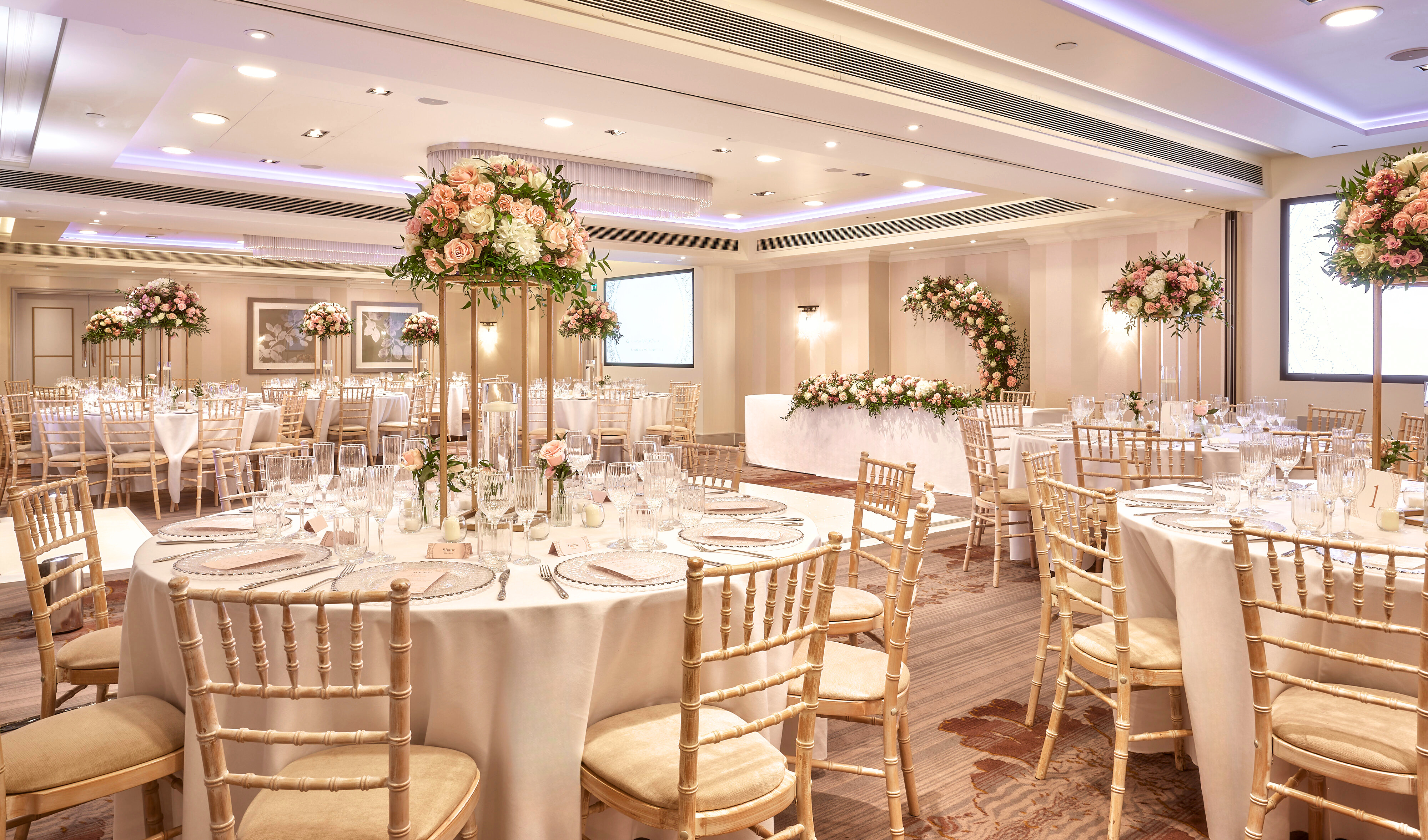 Westminster Suite at Sofitel London, elegant wedding venue with floral centerpieces. - Banner
