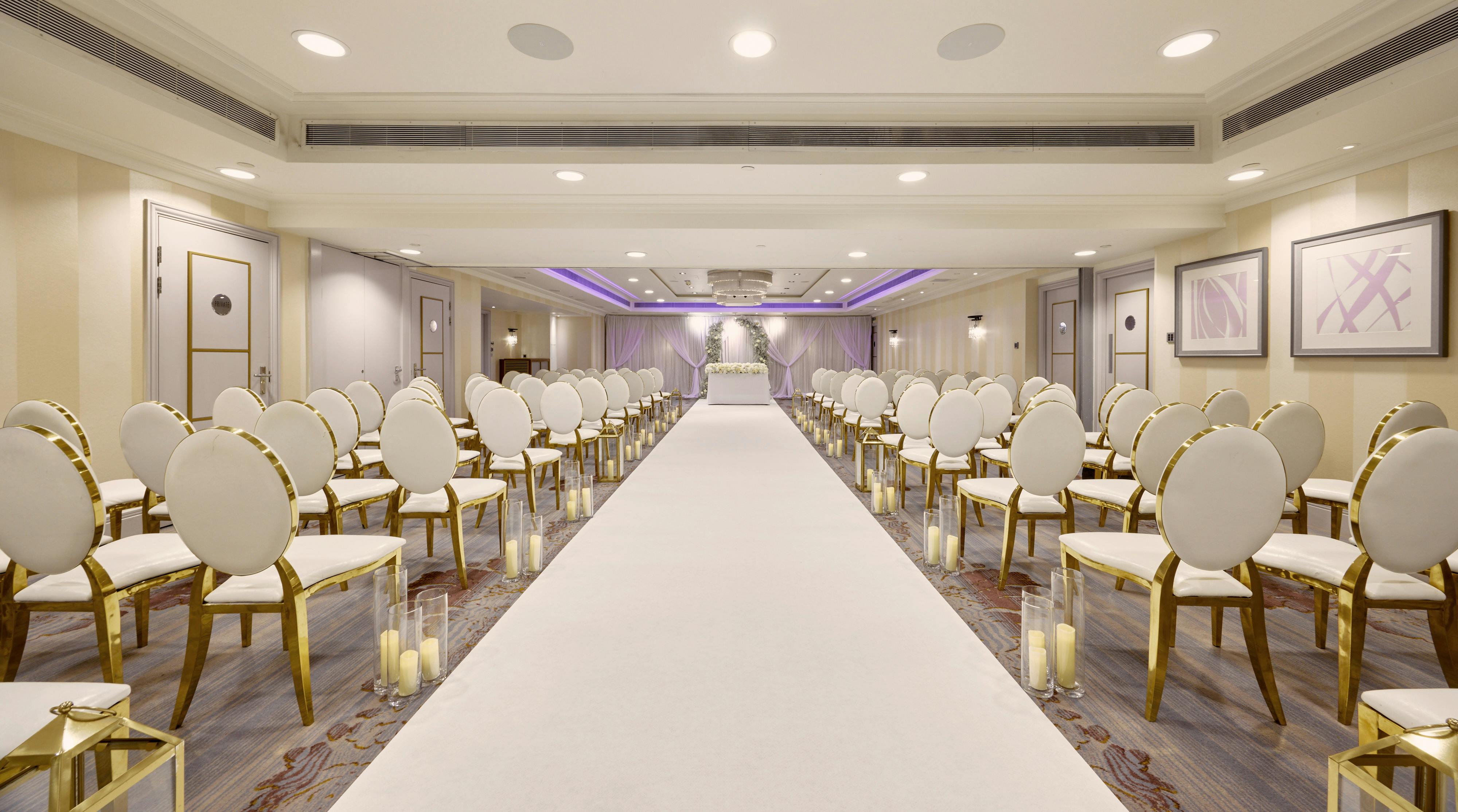 Mayfair Suite at Sofitel London: elegant wedding venue with gold-accented chairs.