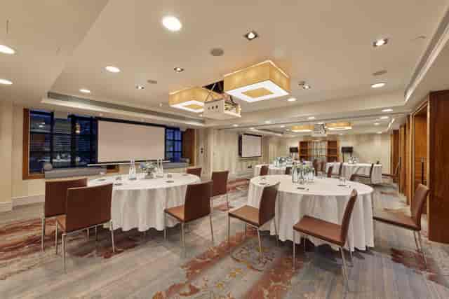 Corporate meeting room at Sofitel London St James with round tables and natural light.