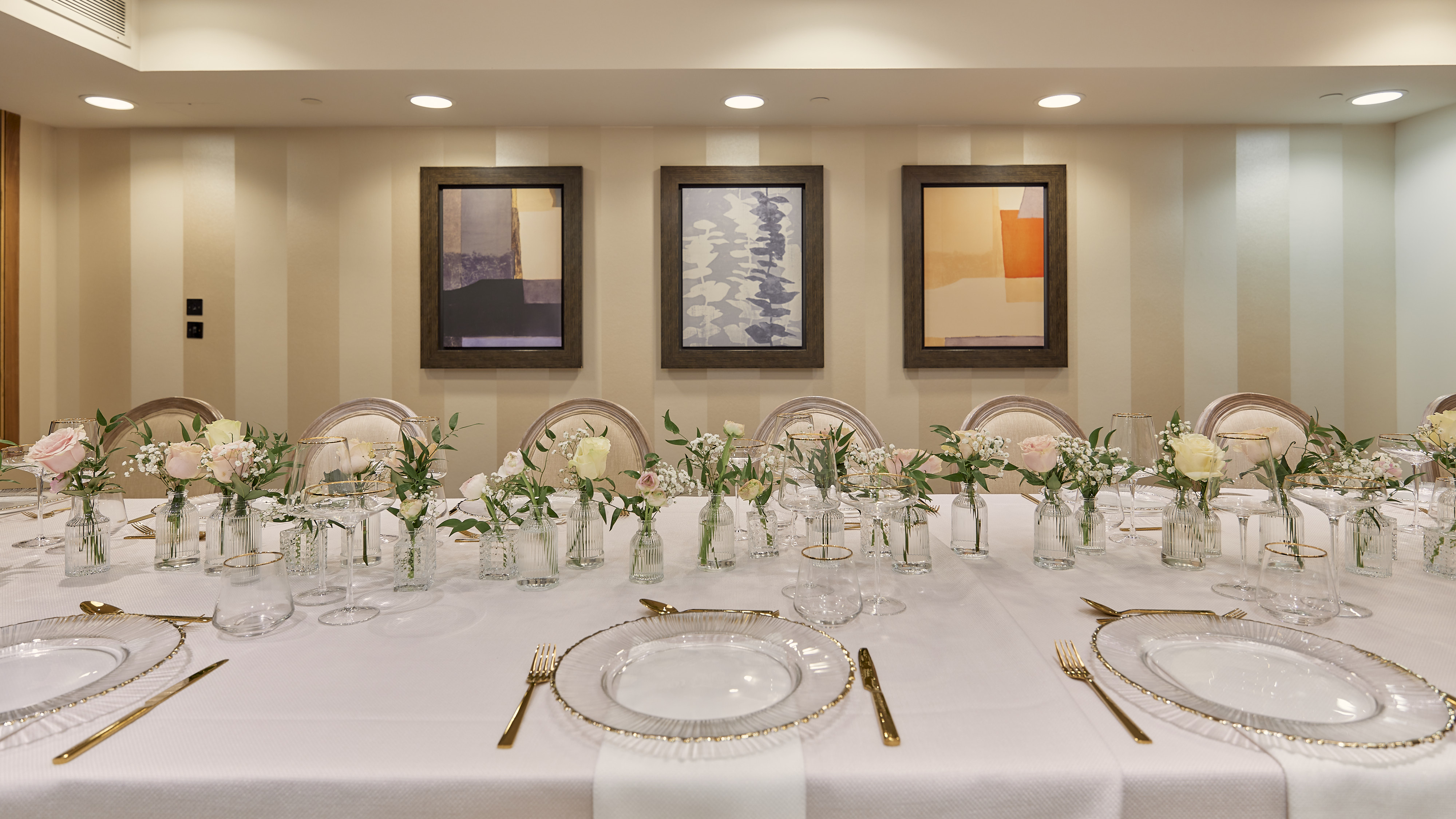 Elegant dining table with floral centerpieces for corporate events in Sofitel London. - Banner