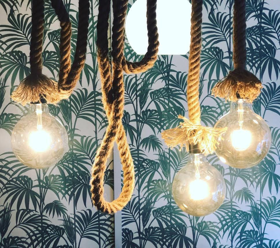 Black Milk Cafe lighting fixture, rustic rope and glass, ideal for casual events.