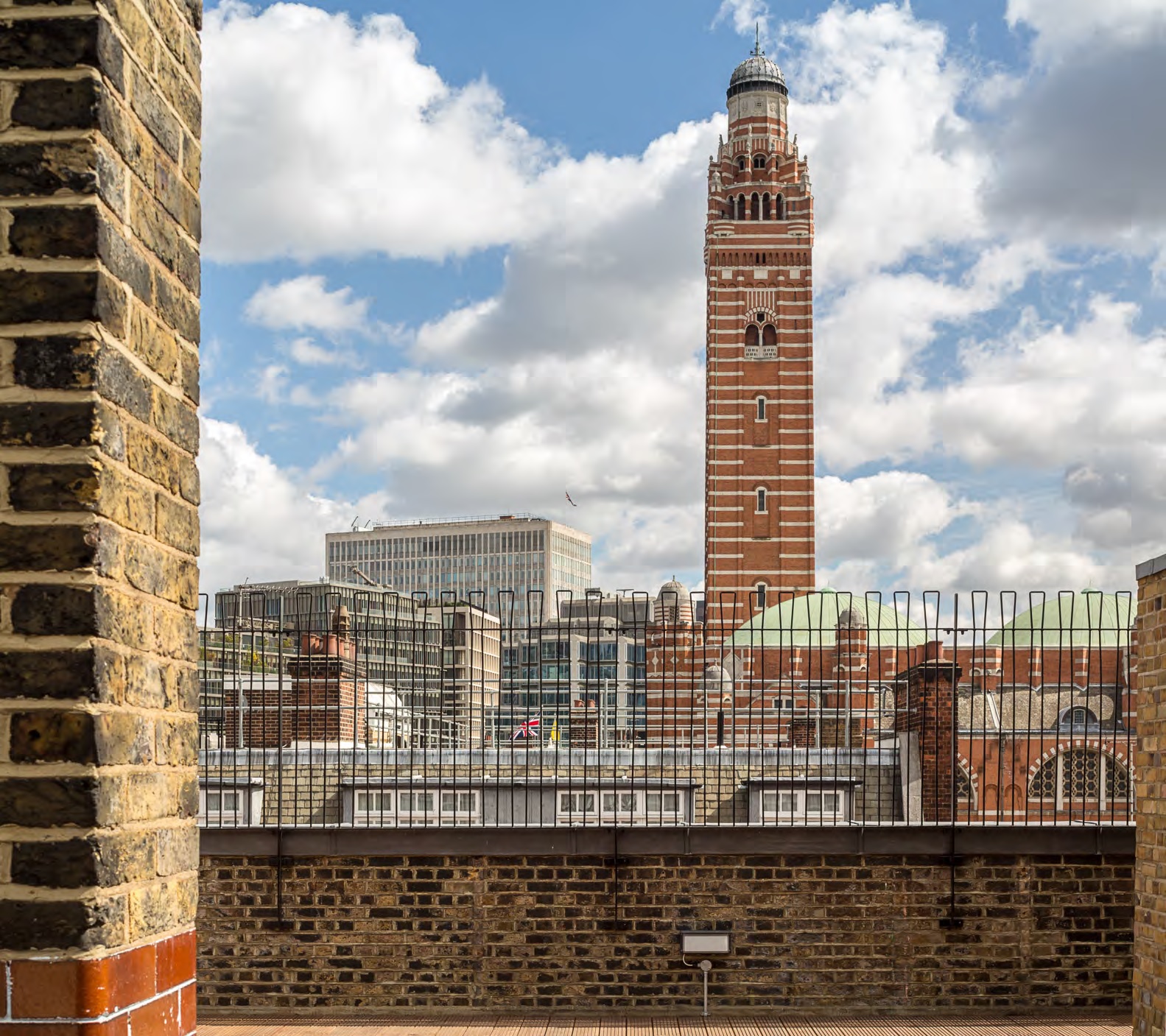 Rooftop garden with clock tower skyline, perfect for urban events and gatherings. - Banner