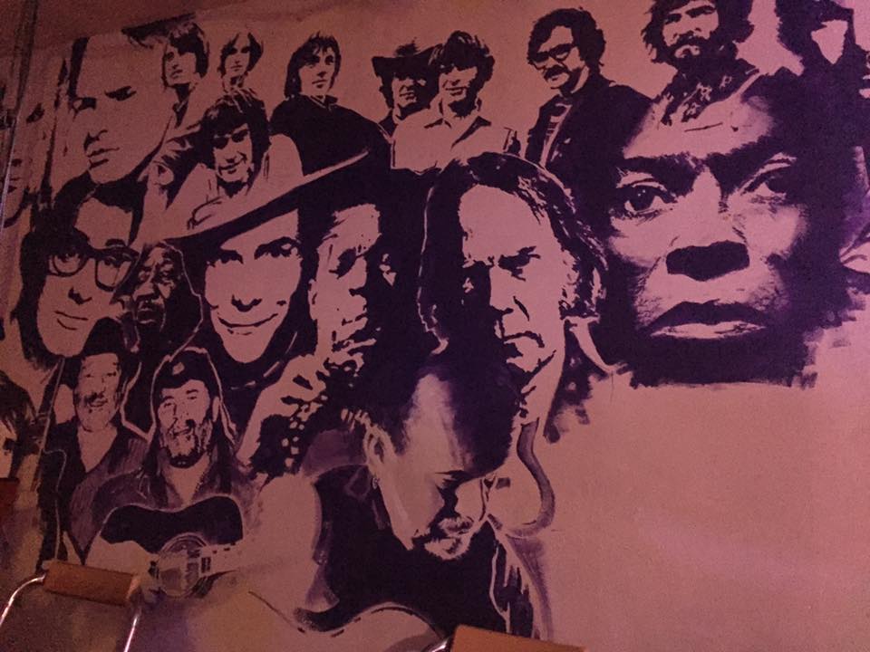 Vibrant mural of iconic musicians at The Tower of Song venue for music events. - Banner