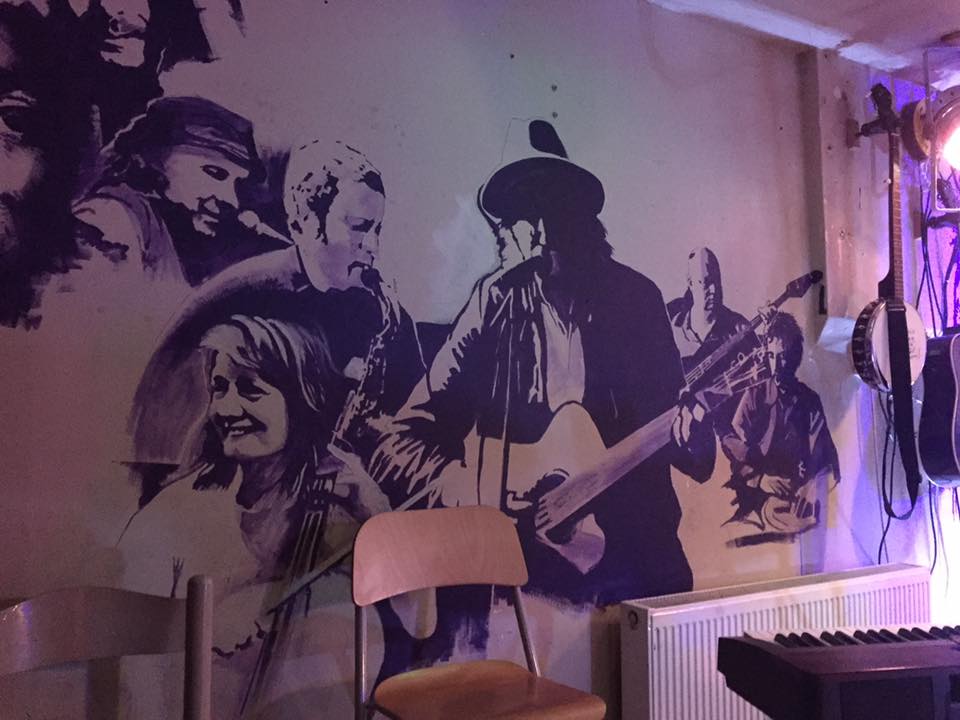 Vibrant mural at The Tower of Song venue, perfect for events and networking. - Banner
