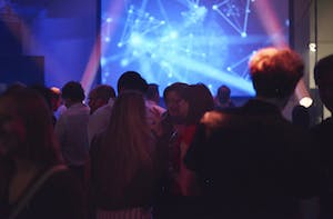 Vibrant networking event in Shoreditch Studios with dynamic lighting and engaging atmosphere.