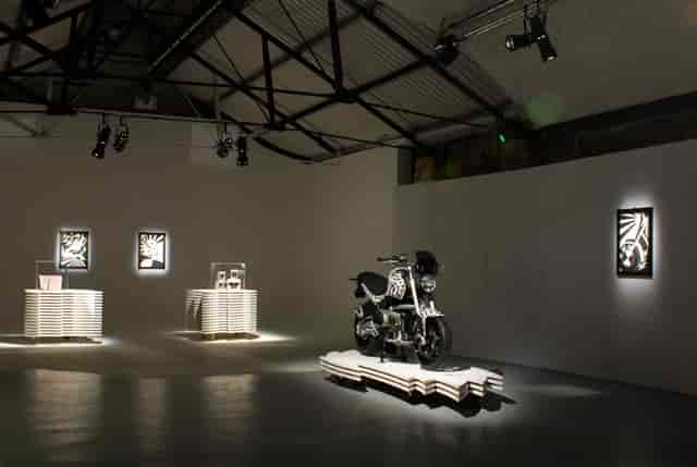 Modern event space in Shoreditch with a striking motorcycle centerpiece for exhibitions.