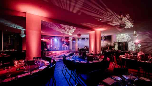Elegant Canalside venue with fine dining setup for corporate events and galas.