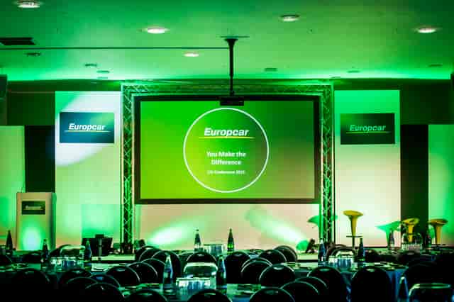 Walkers Hall at Leicester City FC, corporate event space with green lighting and branding.