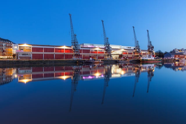 Events Suite in M Shed: modern waterfront venue with evening lights, perfect for gatherings.