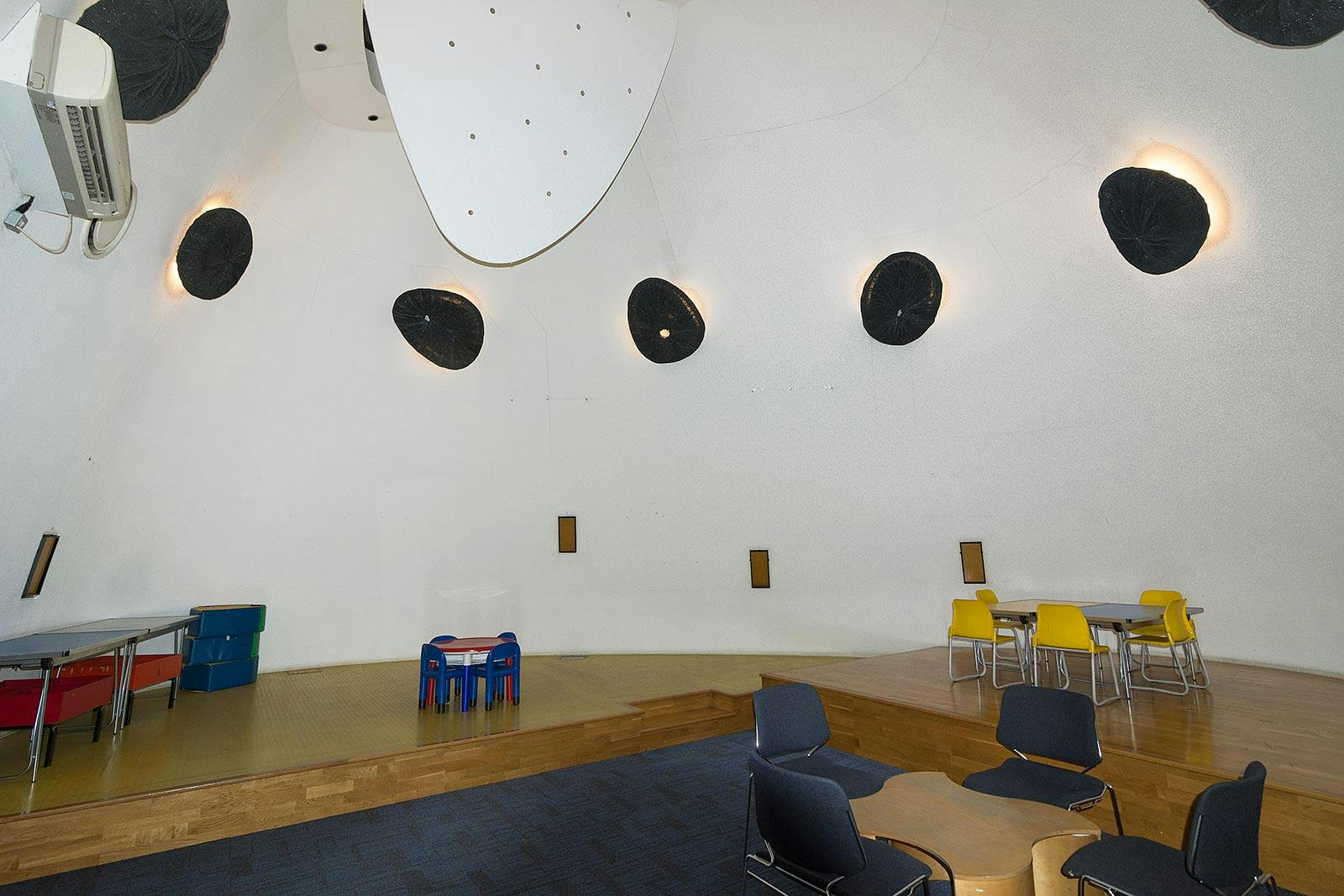 Modern event space with curved walls in Peckham Library for creative meetings and workshops.