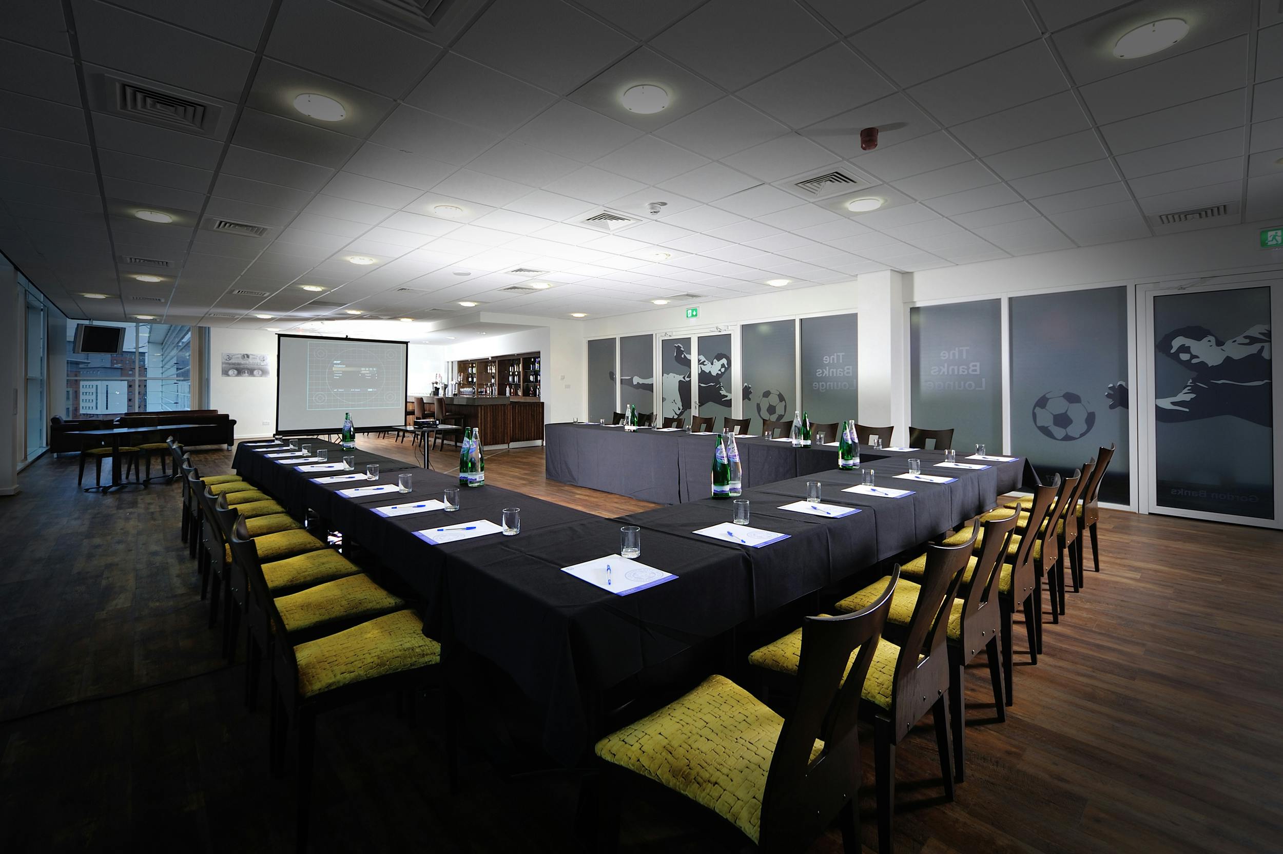 Banks Lounge at Leicester City FC, featuring a long table for corporate meetings and presentations.