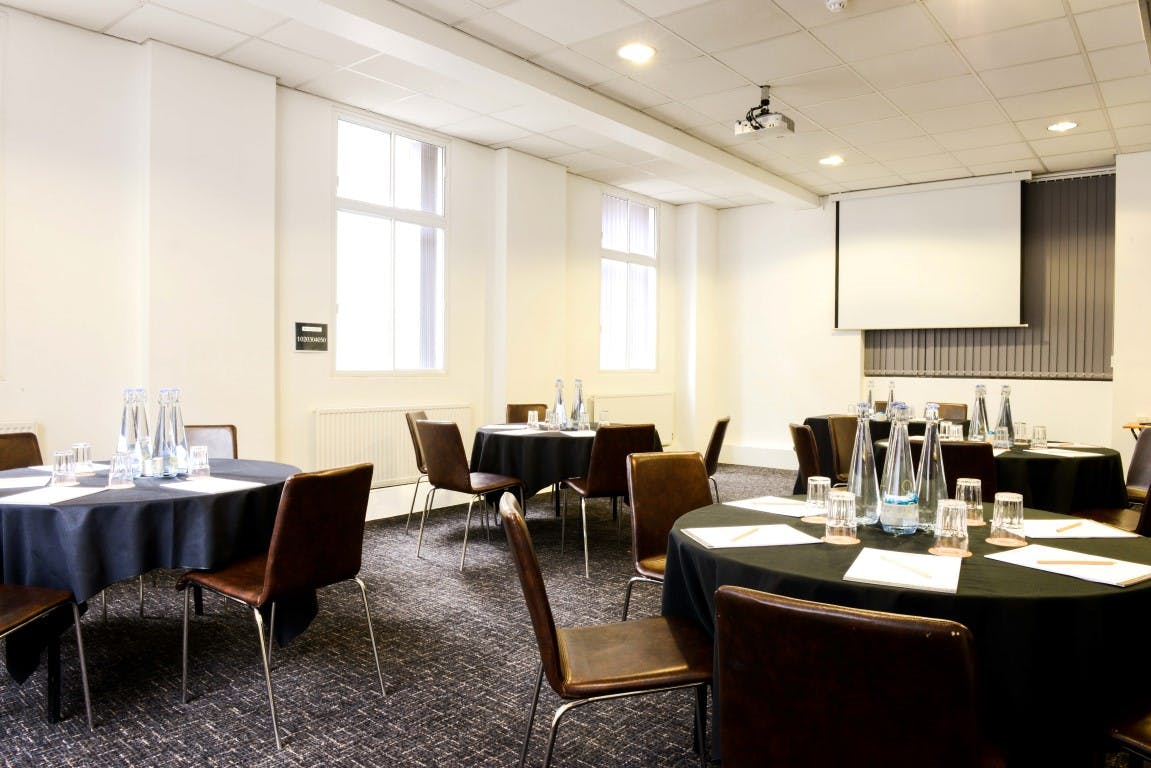 Liverpool conference room with round tables, ideal for corporate meetings and workshops.