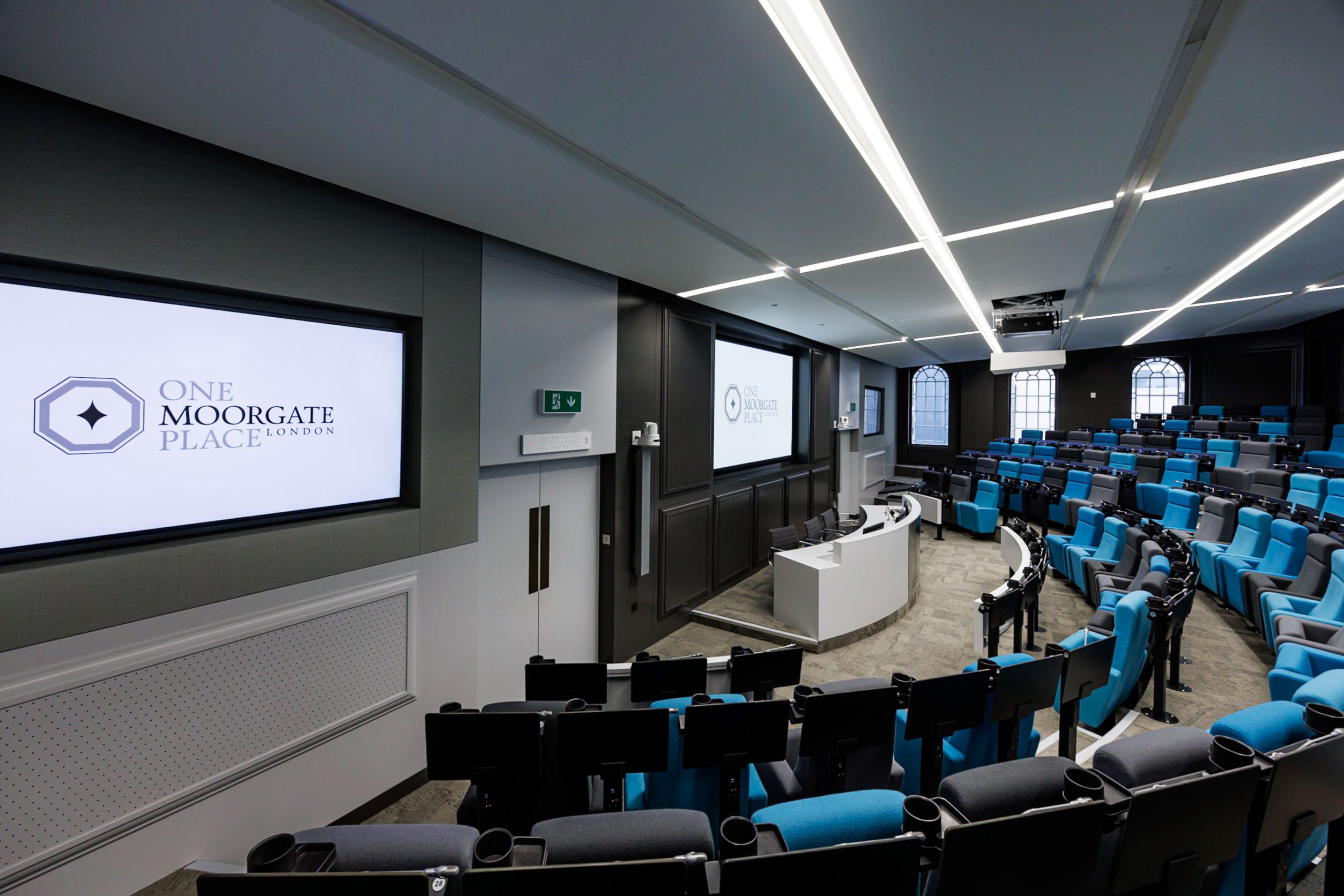 Modern conference room with tiered seating at One Moorgate Place for corporate events. - Banner