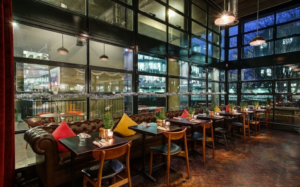 Stylish restaurant venue with warm lighting, ideal for corporate events and gatherings.