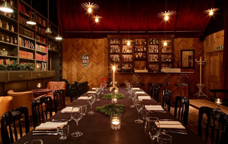 Elegant dining room for intimate gatherings and corporate dinners, featuring warm lighting.