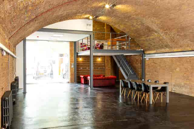 Versatile event space in Rida Haggerston with exposed brick walls, ideal for meetings and gatherings.