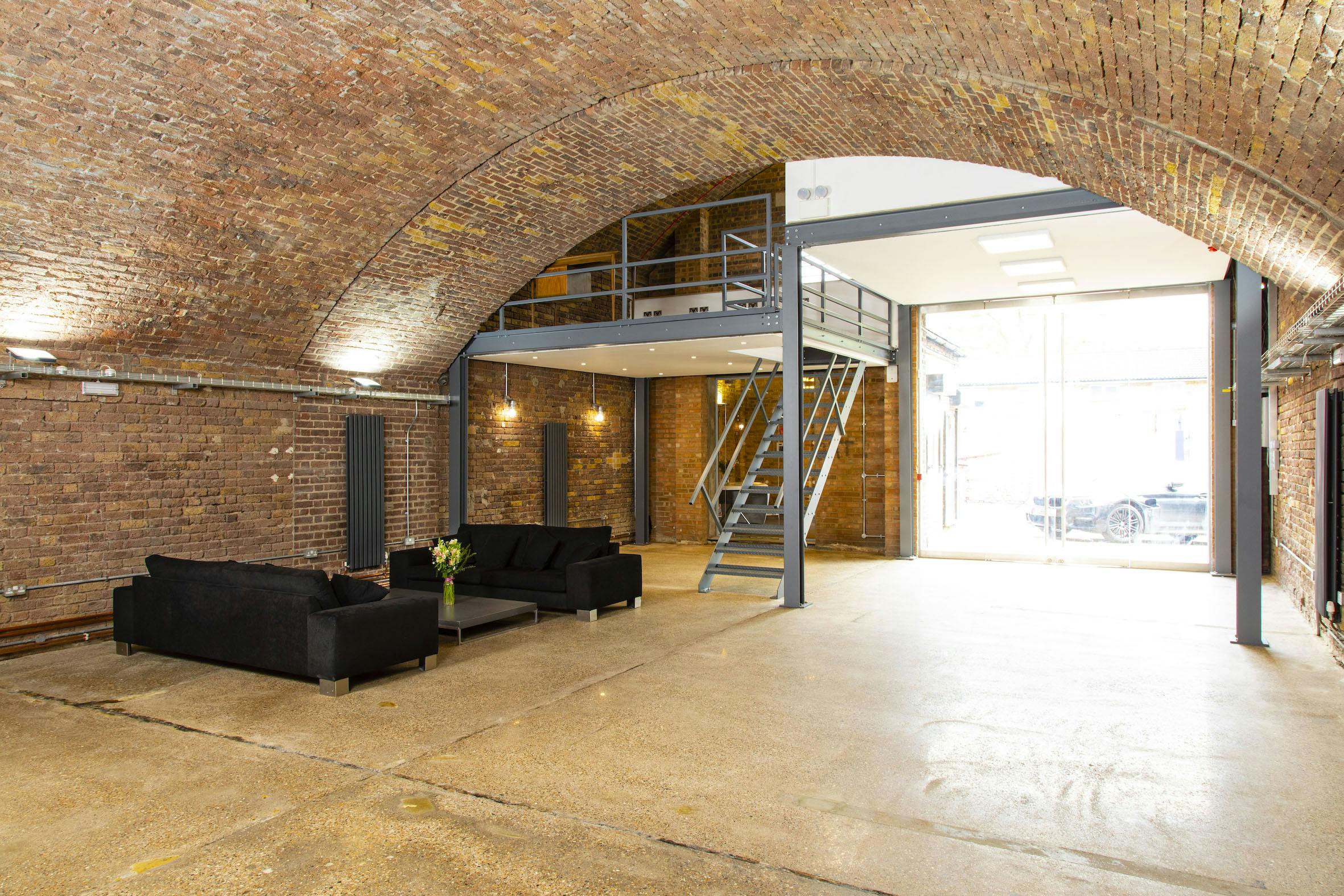 Modern industrial event space with exposed brick, ideal for gatherings and meetings.