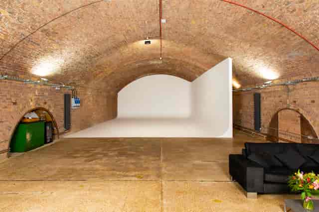 Versatile event space in Rida Haggerston with arched brick ceiling, ideal for corporate events.