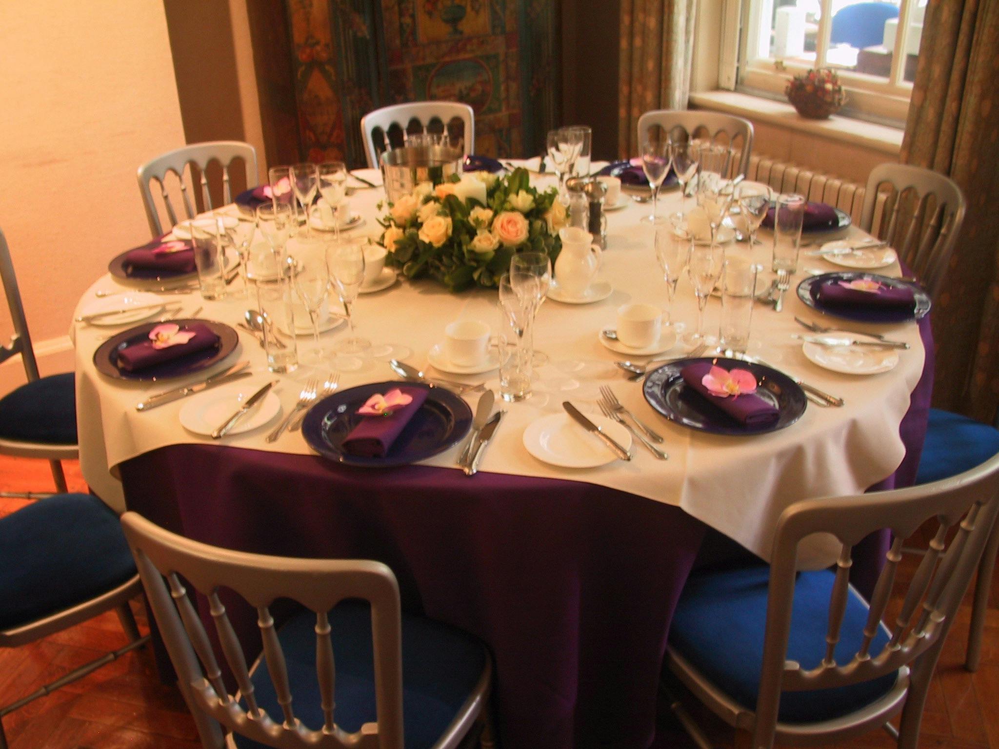 Elegant round table with purple tablecloth in Freud Museum London for formal events.