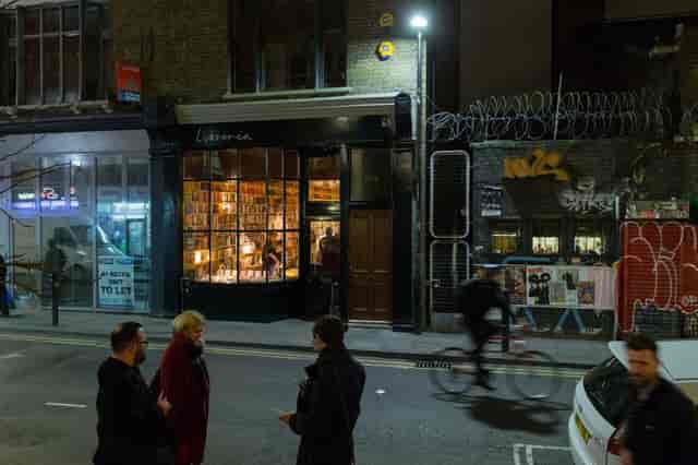 Cozy bookshop venue with large windows, ideal for networking and creative events.