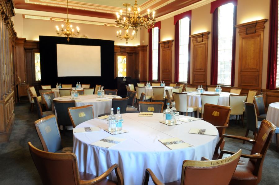 Pewterers' Hall Court Room: elegant corporate event space with round tables and natural light.
