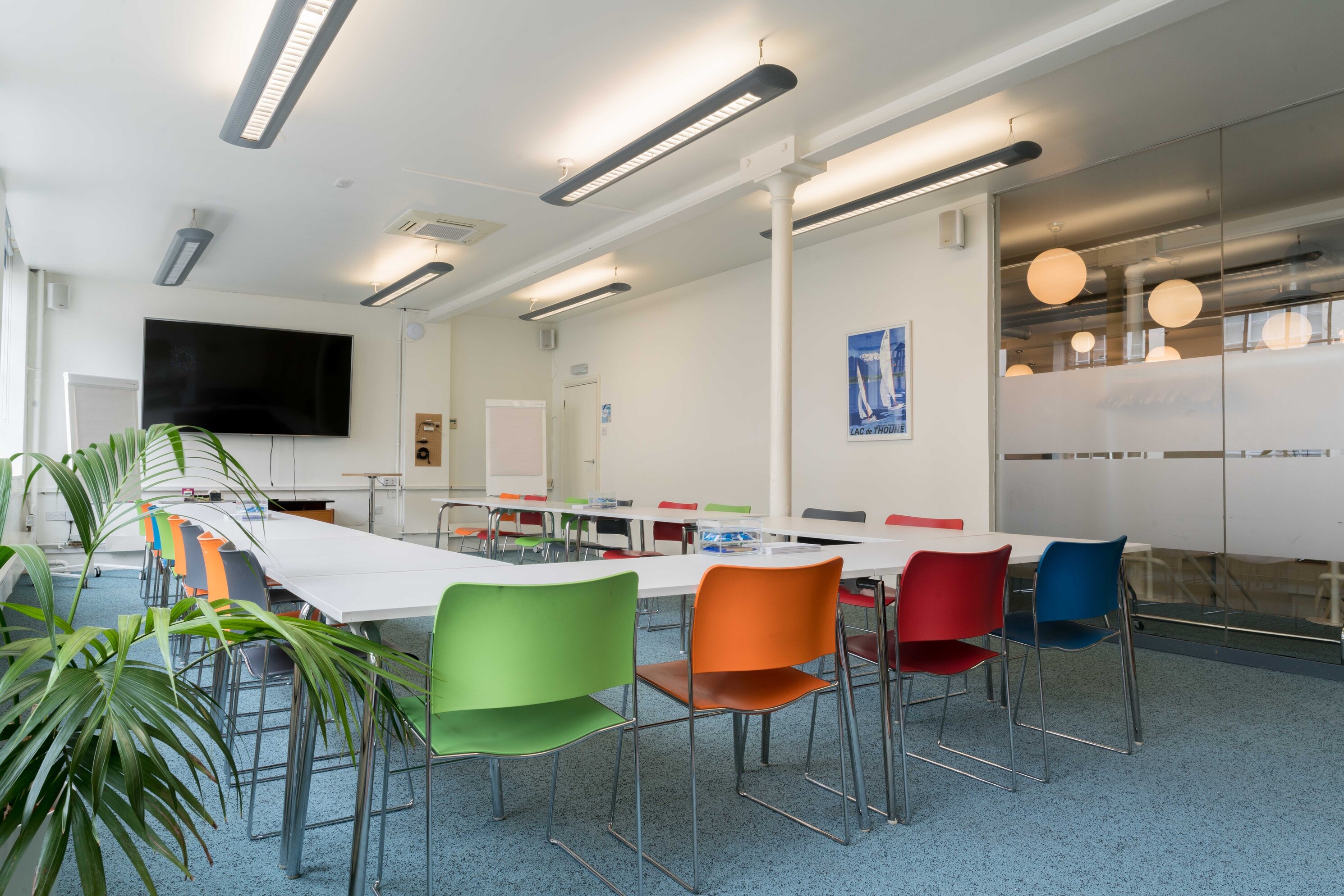 Modern meeting room with colorful chairs for collaborative workshops at Wallacespace St Pancras. - Banner