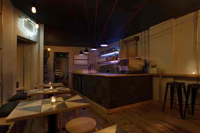 Stylish cafe bar with warm lighting, perfect for networking events and gatherings.