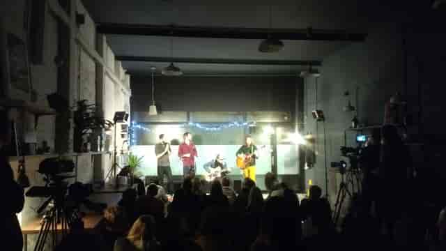 Industrial venue hosting a live-streamed performance for hybrid event production.