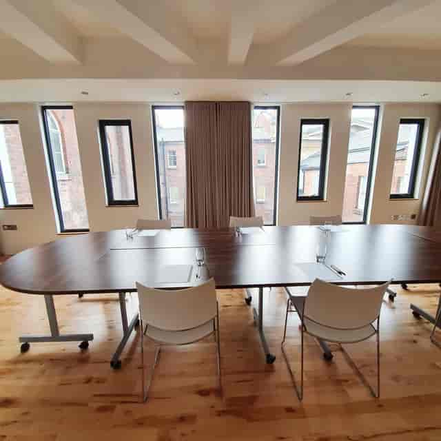 Modern meeting room at Hope Street Hotel with oval table for workshops and collaboration.