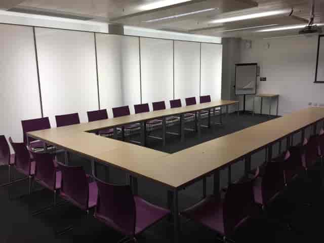 Blomeley Room 1: U-shaped meeting space with purple chairs for workshops and discussions.