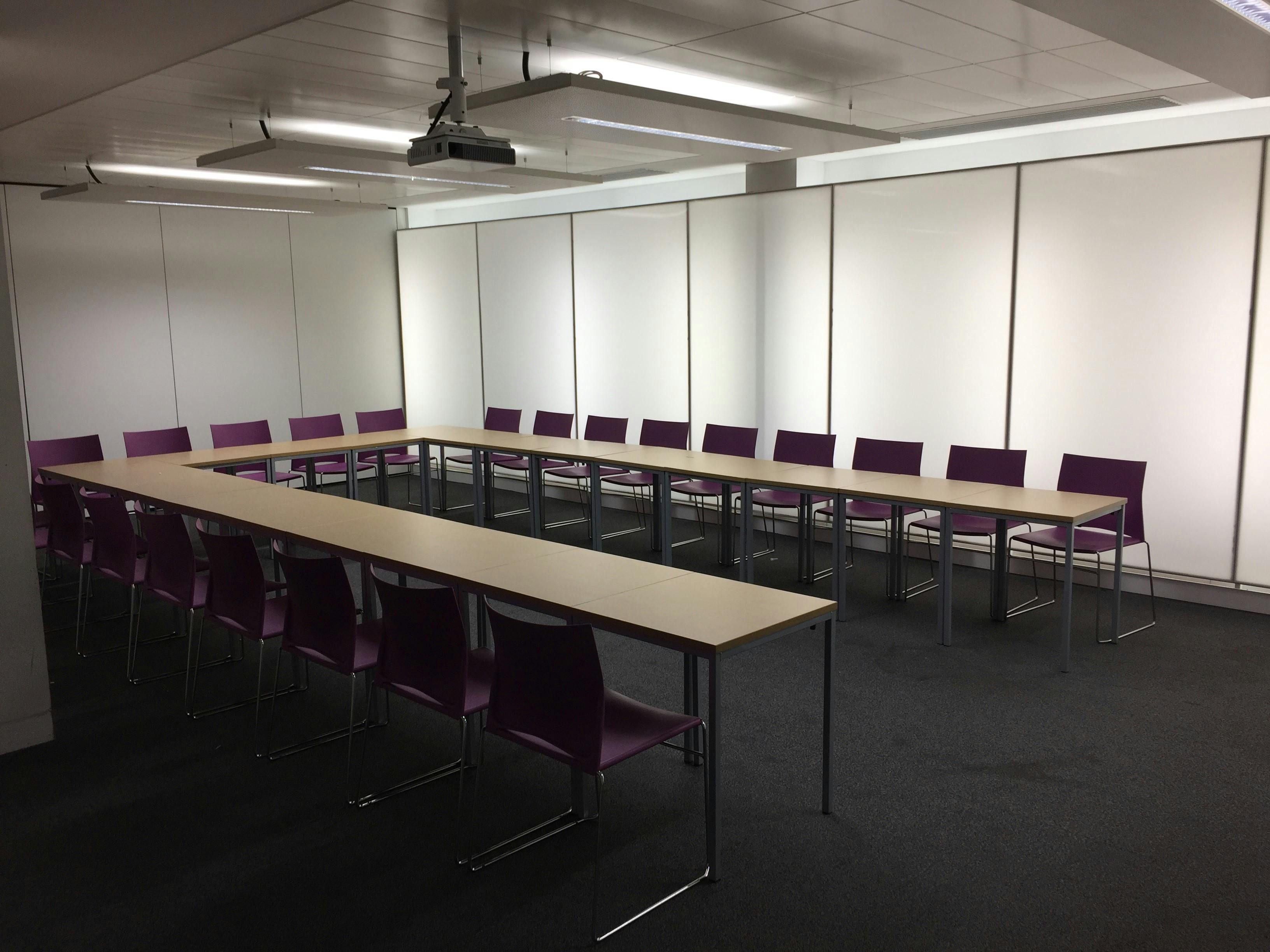 Blomeley Room 1: modern meeting space with purple chairs for workshops and collaboration.