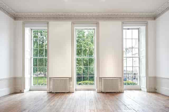 Bright event space in Fitzroy Square House with large windows, ideal for networking and workshops.