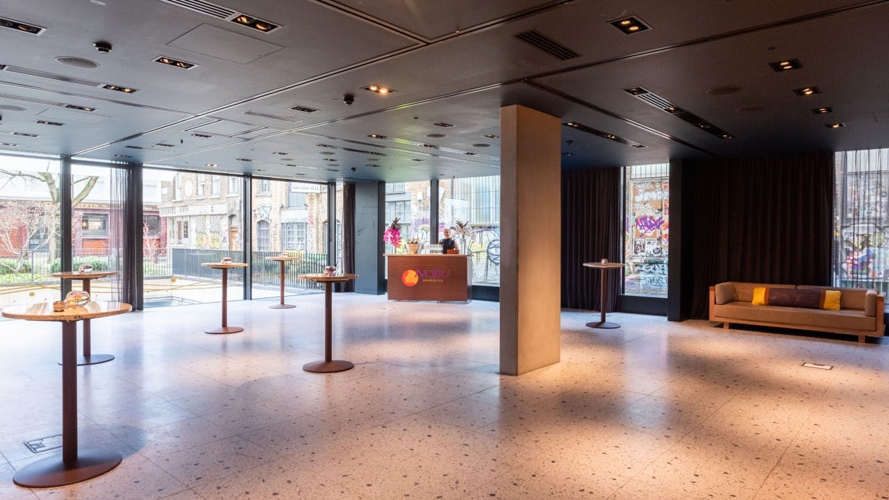 Modern event space at Nobu Hotel London with large windows, perfect for corporate gatherings.