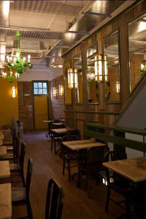 Cozy venue at Cafe Zee, featuring warm lighting for intimate meetings and events.