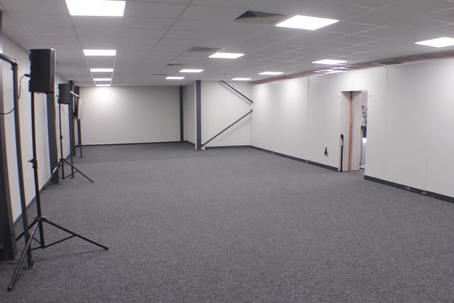 Versatile event space with sound equipment for meetings and presentations at !Audacious Conferencing.