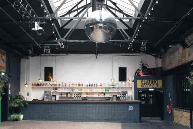 Industrial venue, bar, disco ball, event space, party