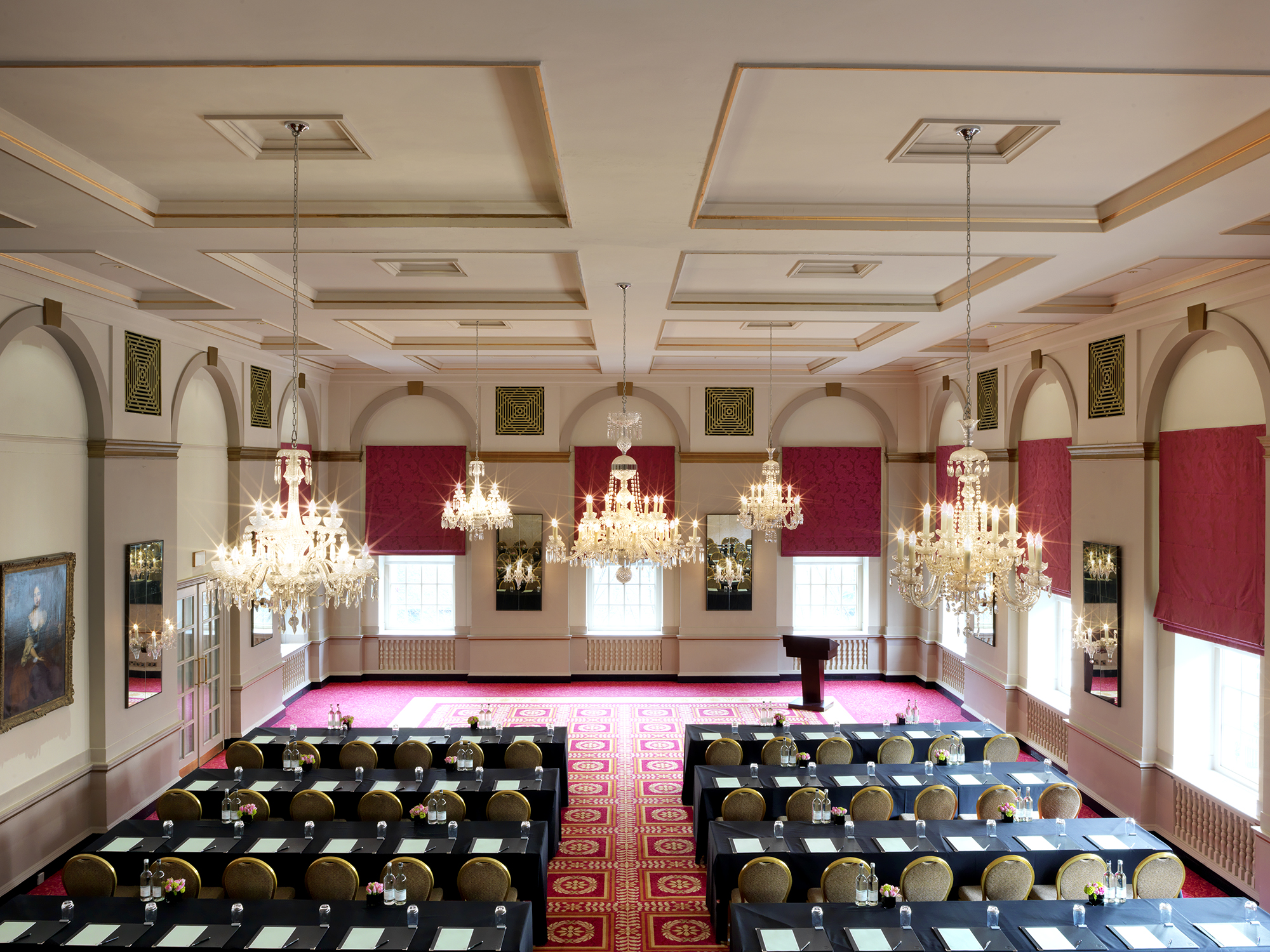 Elegant Queen Mary Hall with chandeliers, ideal for corporate events and formal gatherings.