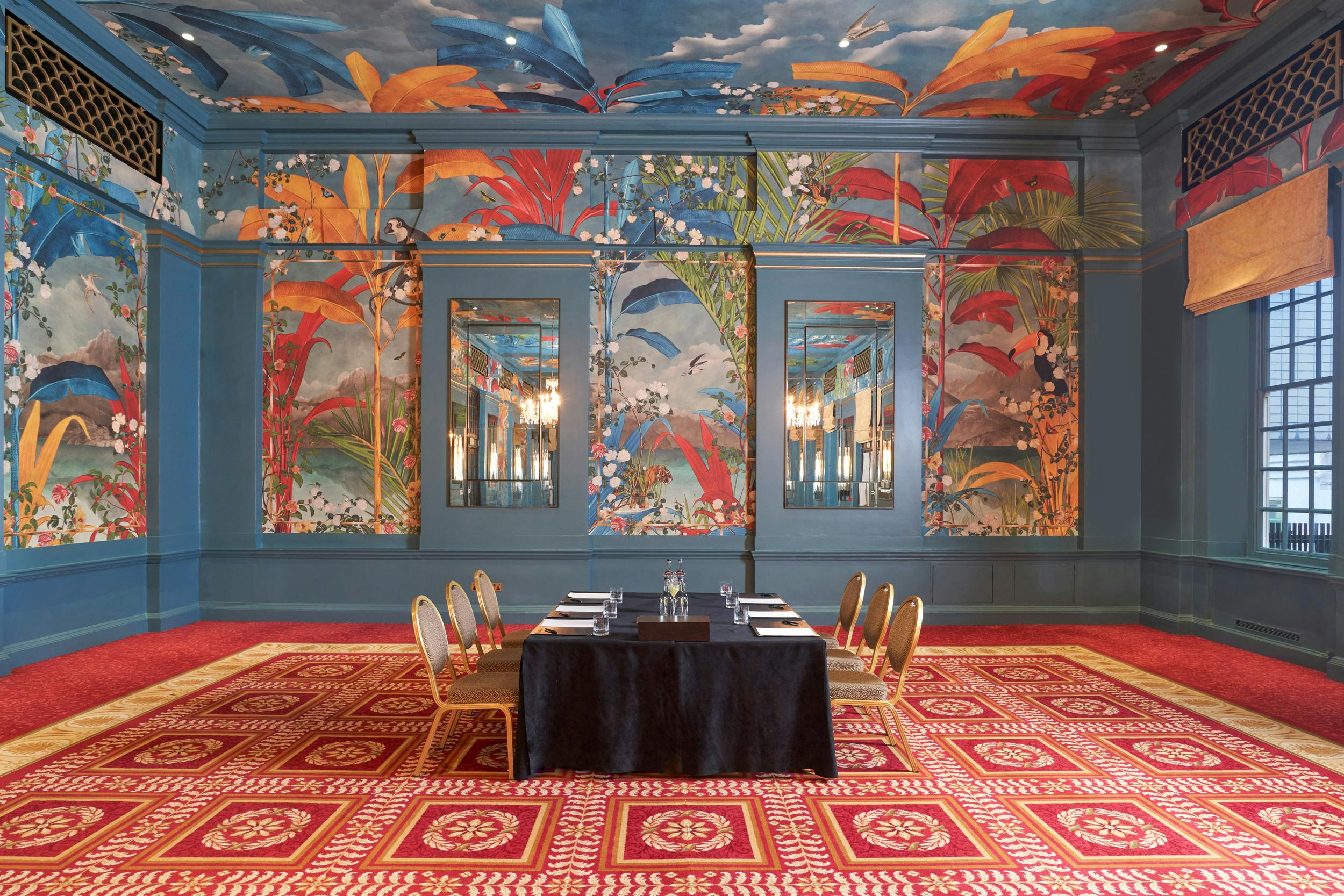 George V meeting room with vibrant murals, ideal for discussions and presentations.