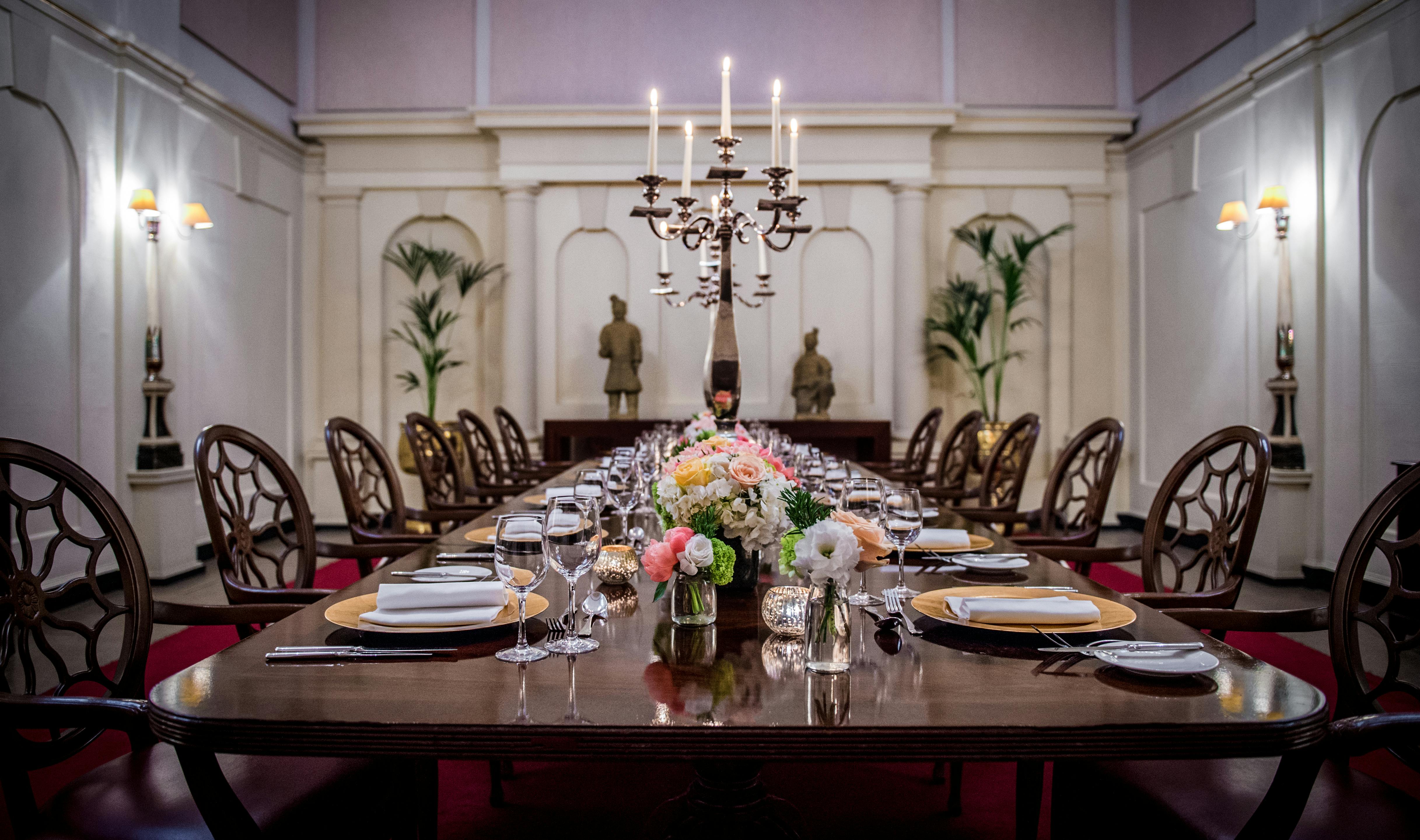 Elegant dining table with floral arrangements in The Chapel, ideal for corporate events.